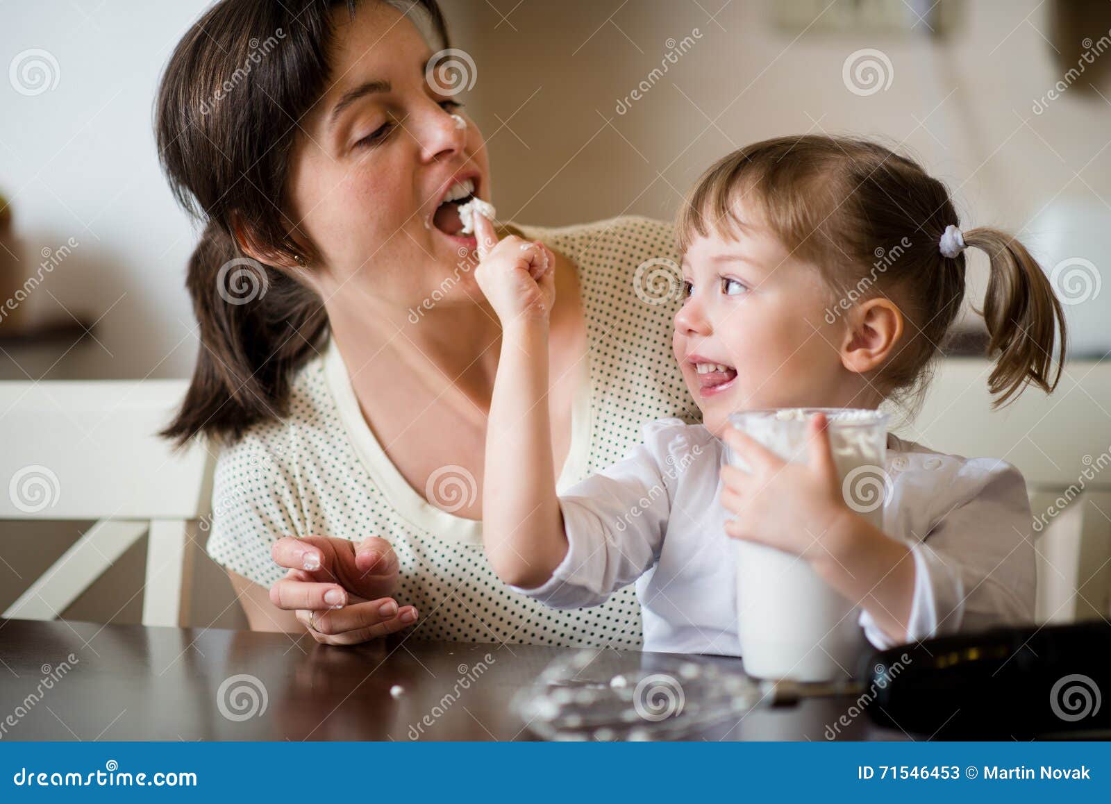 mother and daughter licking